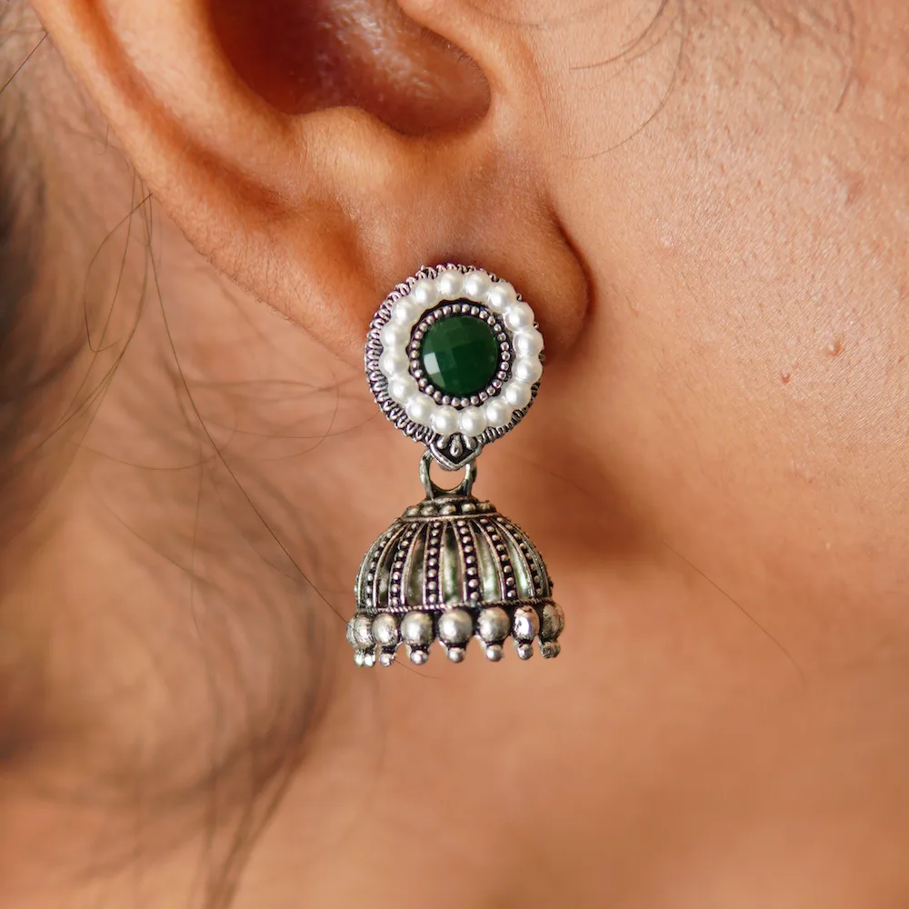 Close-up of moti jhumka earrings showing intricate pearl detailing