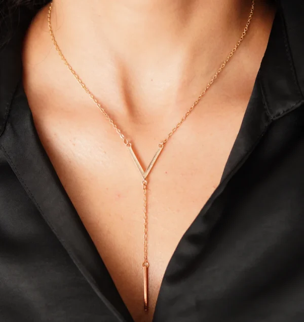 Elegant gold pendant necklace styled on model – Huviena