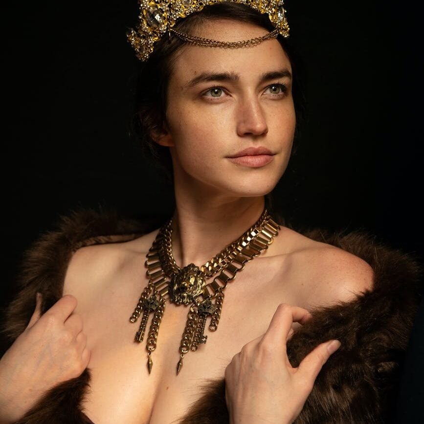 model in medieval gold jewelry and a fox shawl